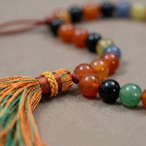Close up of 10mm Aqeeq stone beads showing mixed natural colors
