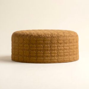 Side profile of golden beige Islamic cap showing structured hard material