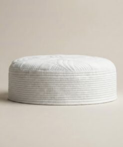 Side profile of white Islamic kufi cap showing structured hard material