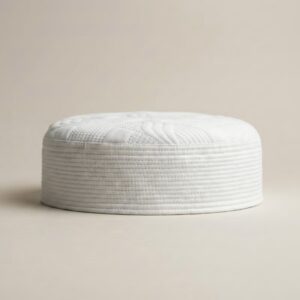 Side profile of white Islamic kufi cap showing structured hard material