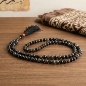 Black Aqeeq 100 bead misbaha placed on prayer mat Islamic setting