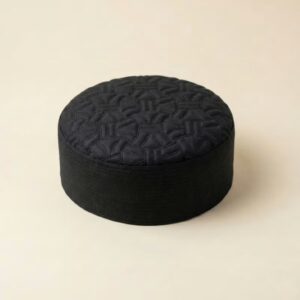 Top view of black self print Muslim prayer cap with textured design