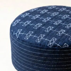 Close up texture of navy blue kufi cap premium stitching detail