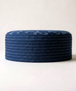 Side profile of navy blue Islamic cap showing structured hard material