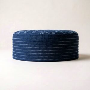 Side profile of navy blue Islamic cap showing structured hard material
