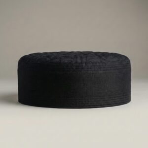 Side profile of black Islamic kufi cap showing hard structured material