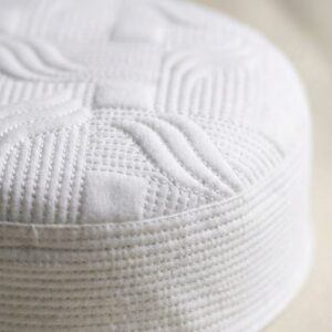 Close up texture of white Muslim prayer cap premium stitching