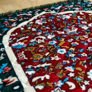 Close up of a royal heritae luxury style janamaz Muslim prayer mat