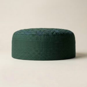 Side profile of green Islamic cap showing structured hard material