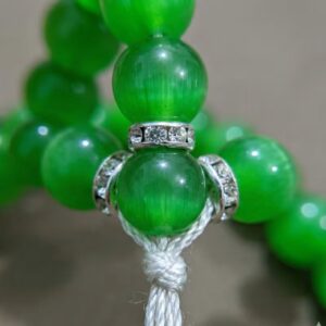 Close up of parrot green marble finish tasbeeh beads solid color