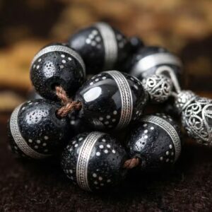 Close up of silver engraved natural Kokka tasbeeh beads