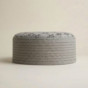 Side profile of cream Islamic kufi cap showing structured hard material