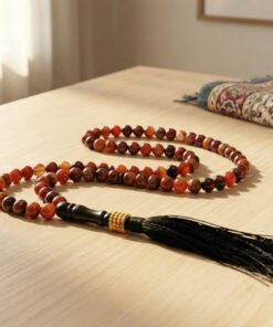 Aqeeq 100 bead misbaha placed on prayer mat Islamic setting