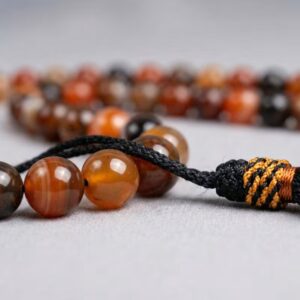 Close up of 6mm Aqeeq stone beads natural polished texture