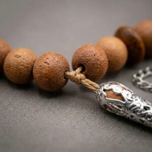 Close up of sandalwood tasbeeh beads showing natural wood texture